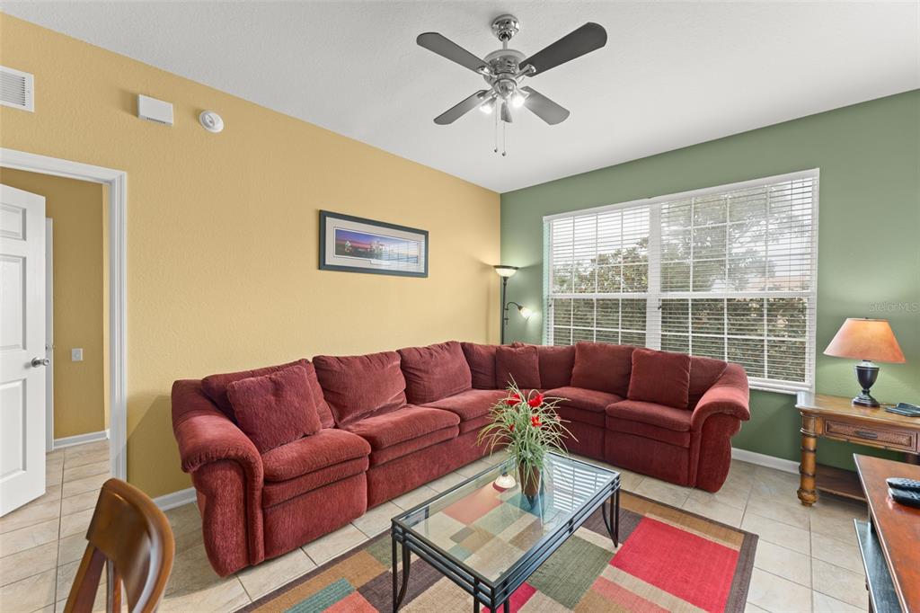 7675 Comrow Street, Unit 405 Kissimmee, FL 34747 - Photo 12 of 40 a living room with furniture and a window