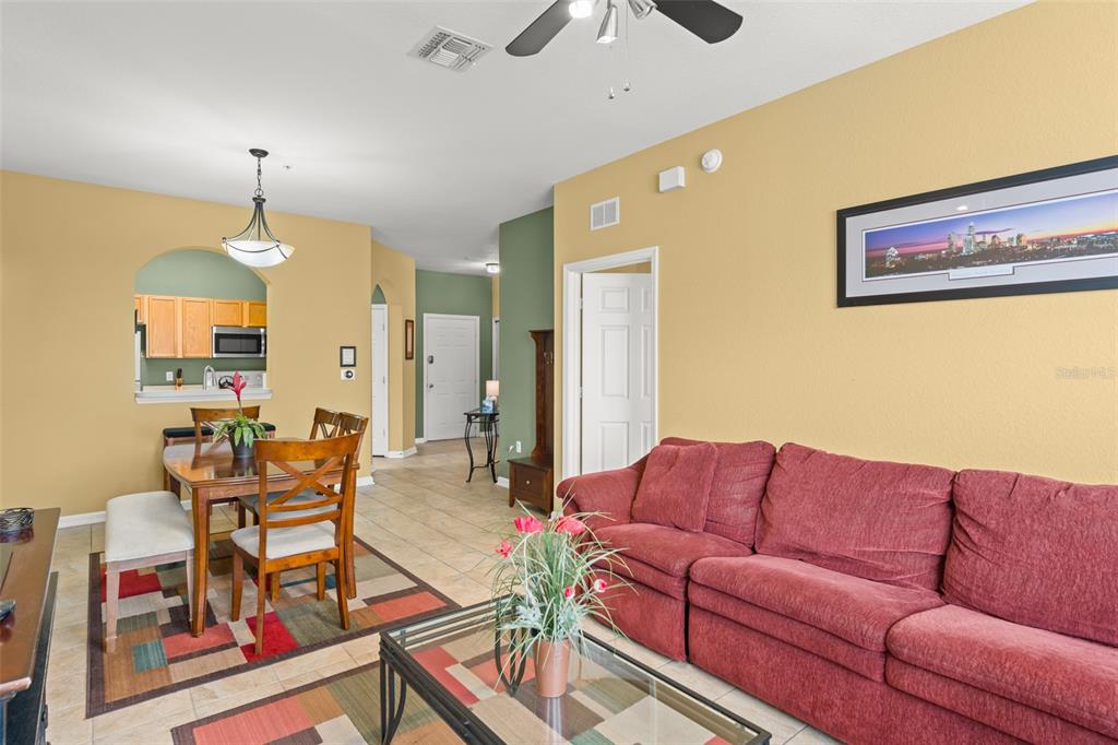 7675 Comrow Street, Unit 405 Kissimmee, FL 34747 - Photo 13 of 40 a living room with furniture a dining table and chairs