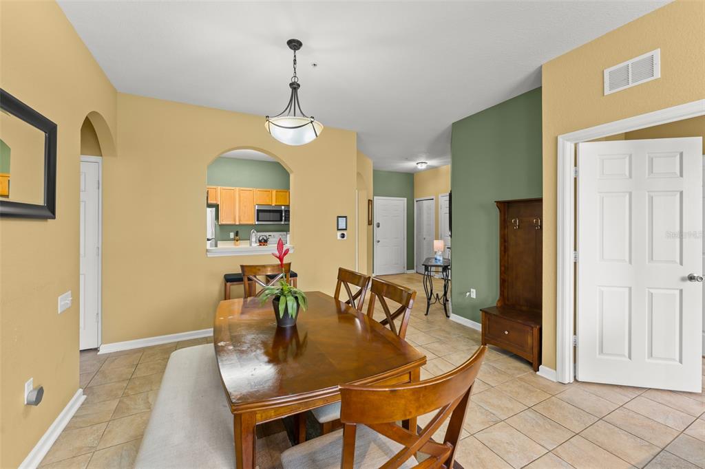 7675 Comrow Street, Unit 405 Kissimmee, FL 34747 - Photo 14 of 40 a dining room with furniture and window