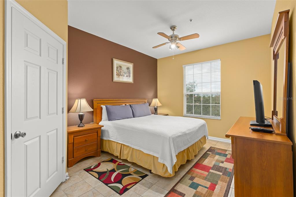 7675 Comrow Street, Unit 405 Kissimmee, FL 34747 - Photo 15 of 40 a bedroom with a bed and a chandelier
