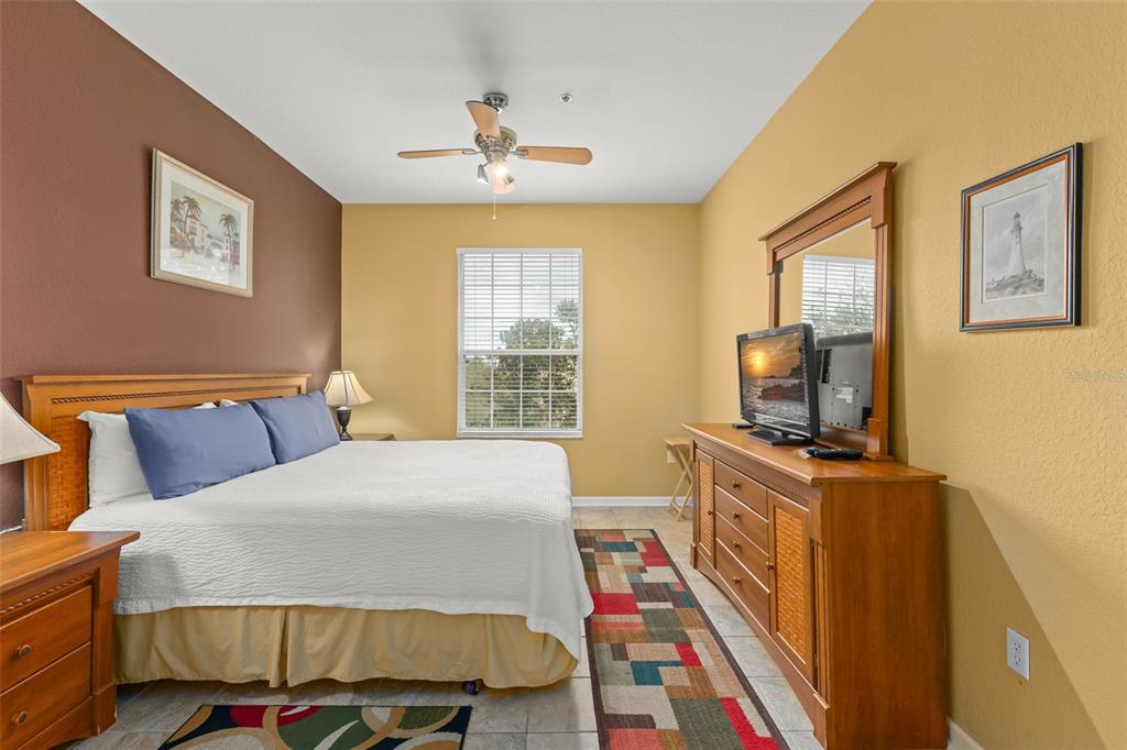 7675 Comrow Street, Unit 405 Kissimmee, FL 34747 - Photo 16 of 40 a bedroom with a bed and a flat screen tv
