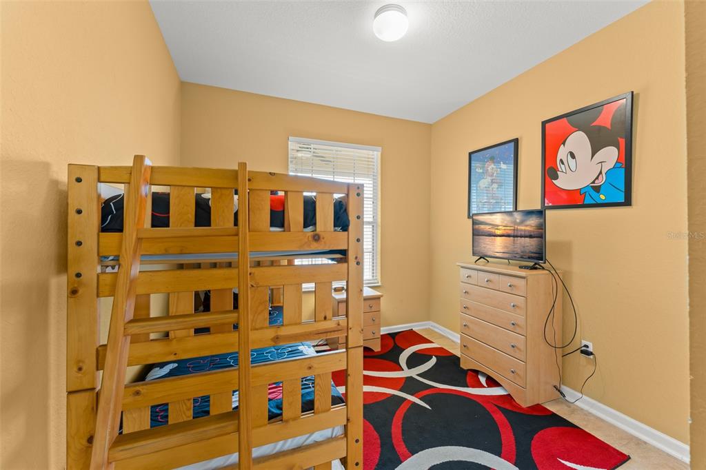 7675 Comrow Street, Unit 405 Kissimmee, FL 34747 - Photo 20 of 40 a bedroom with a bed and a cabinets