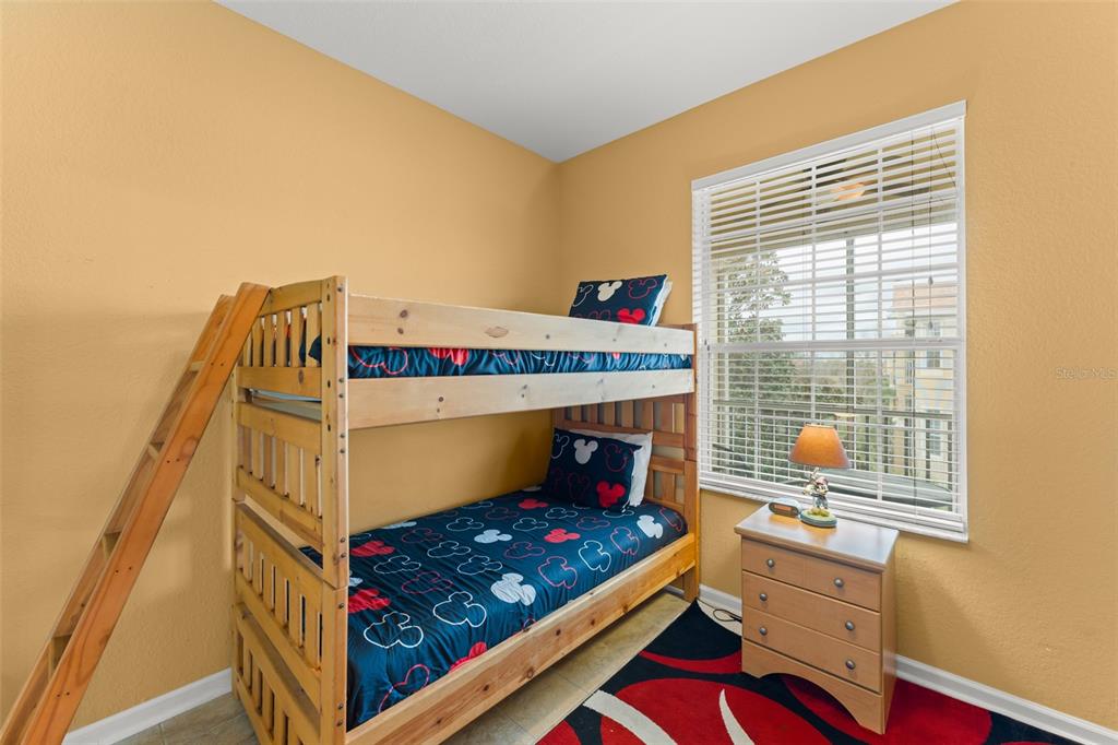 7675 Comrow Street, Unit 405 Kissimmee, FL 34747 - Photo 21 of 40 a bed room with a bed and a window