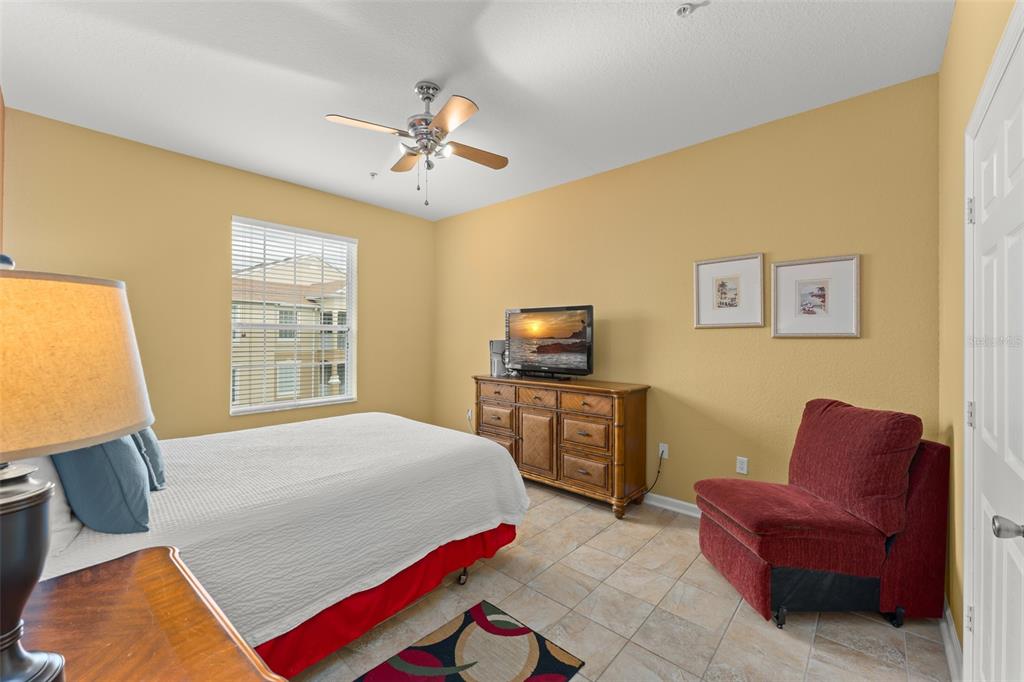 7675 Comrow Street, Unit 405 Kissimmee, FL 34747 - Photo 23 of 40 a bedroom with a bed and wooden floor