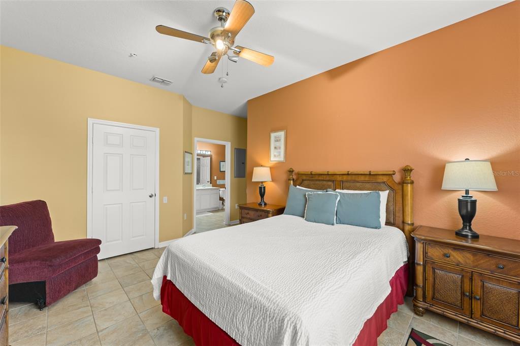 7675 Comrow Street, Unit 405 Kissimmee, FL 34747 - Photo 24 of 40 a bed room with a bed and a chandelier