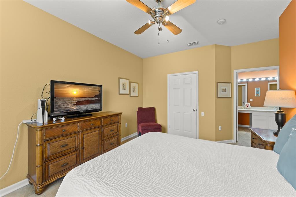 7675 Comrow Street, Unit 405 Kissimmee, FL 34747 - Photo 25 of 40 a bedroom with a bed and a flat screen tv