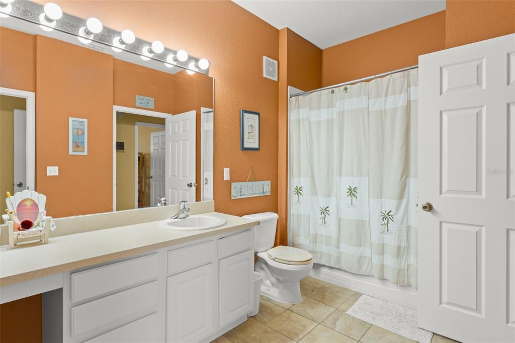 7675 Comrow Street, Unit 405 Kissimmee, FL 34747 - Photo 26 of 40 a bathroom with a double vanity sink toilet and shower