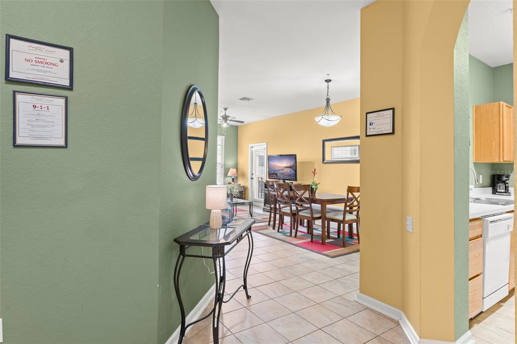7675 Comrow Street, Unit 405 Kissimmee, FL 34747 - Photo 3 of 40 a view of a dining room with furniture and a chandelier