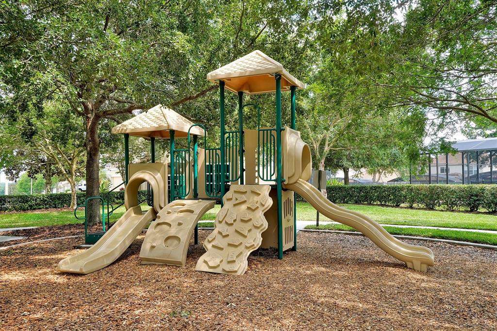 7675 Comrow Street, Unit 405 Kissimmee, FL 34747 - Photo 39 of 40 a view of a house with backyard water fountain and a table