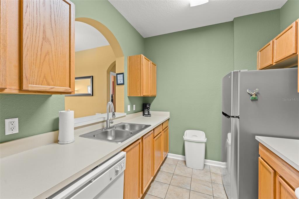 7675 Comrow Street, Unit 405 Kissimmee, FL 34747 - Photo 6 of 40 a bathroom with a sink a toilet and mirror