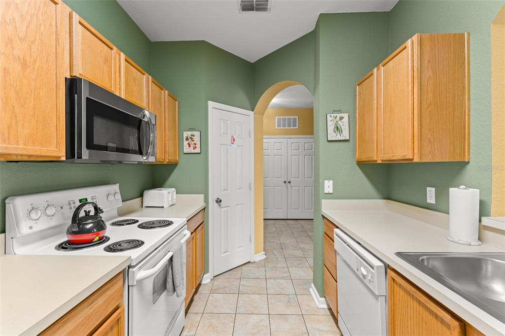 7675 Comrow Street, Unit 405 Kissimmee, FL 34747 - Photo 7 of 40 a kitchen that has a sink and a stove top oven
