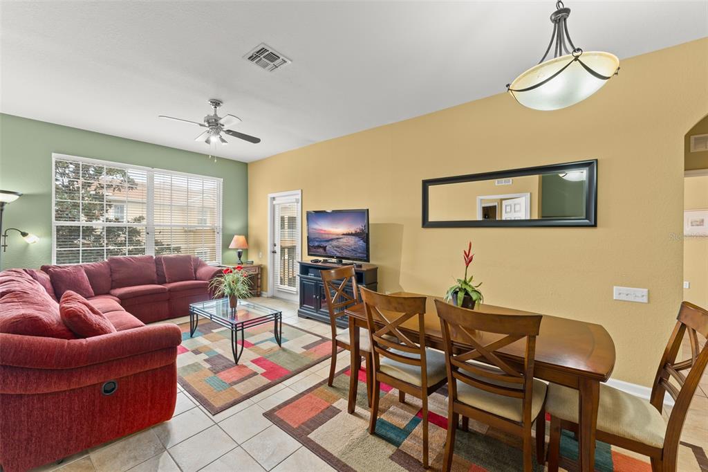 7675 Comrow Street, Unit 405 Kissimmee, FL 34747 - Photo 9 of 40 a living room with furniture a rug and a window