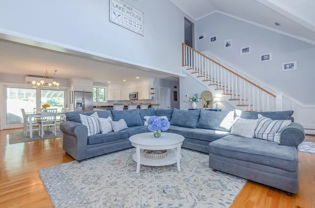 a living room with furniture and view of kitchen