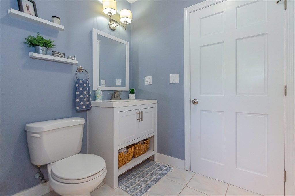 1-3 Doctor Hickey Lane Rochester, MA 02770 - Photo 14 of 38 a bathroom with a toilet a sink and mirror