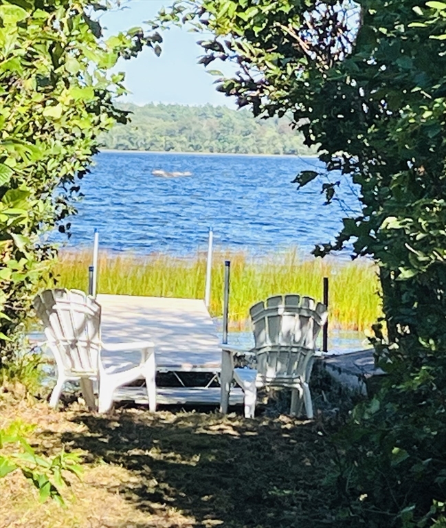 1-3 Doctor Hickey Lane Rochester, MA 02770 - Photo 36 of 38 a view of a patio with table and chairs under an umbrella