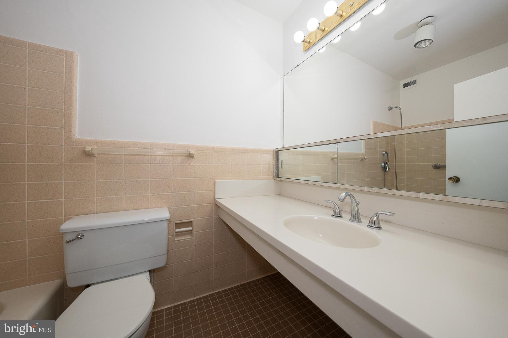 191 Presidential Boulevard, Unit R402 Bala Cynwyd, PA 19004 - Photo 15 of 27 a bathroom with a sink a toilet and mirror