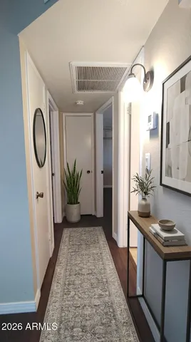 a view of a hallway with furniture