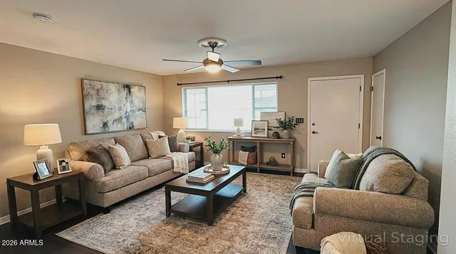 a living room with furniture ceiling fan and a rug