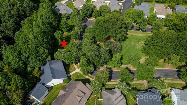 an aerial view of a house with a yard and garden