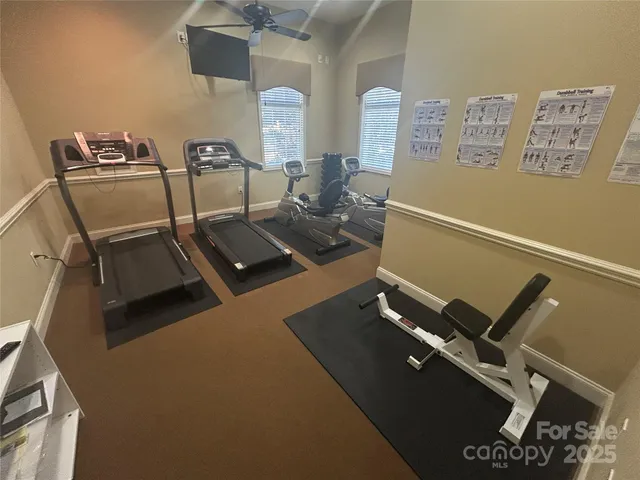 a living room with furniture chandelier and a large window