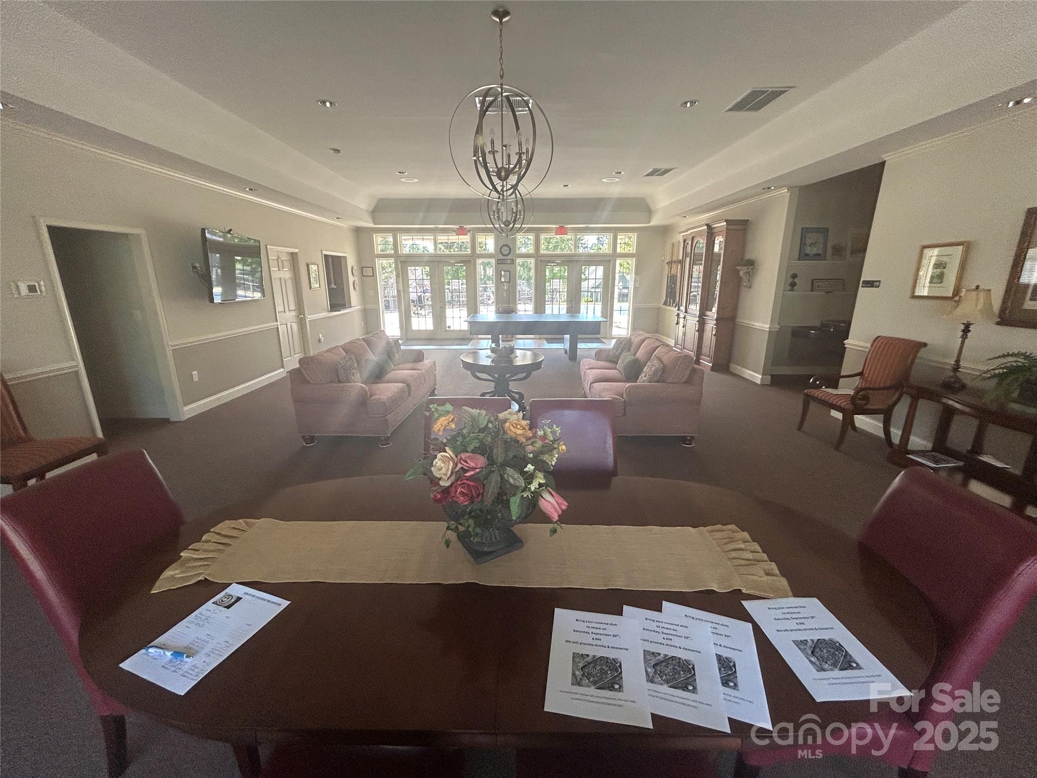 13004 Park Crescent Circle, Unit 85 Pineville, NC 28134 - Photo 7 of 9 a living room with furniture chandelier and a large window