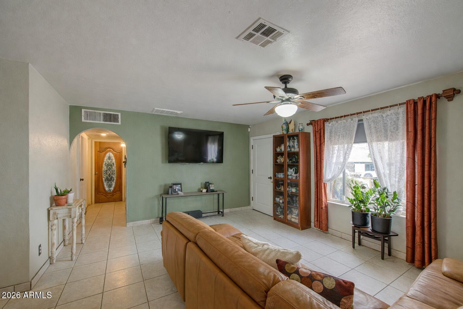 3107 West Montebello Avenue Phoenix, AZ 85017 - Photo 6 of 30 a living room with furniture and a potted plant