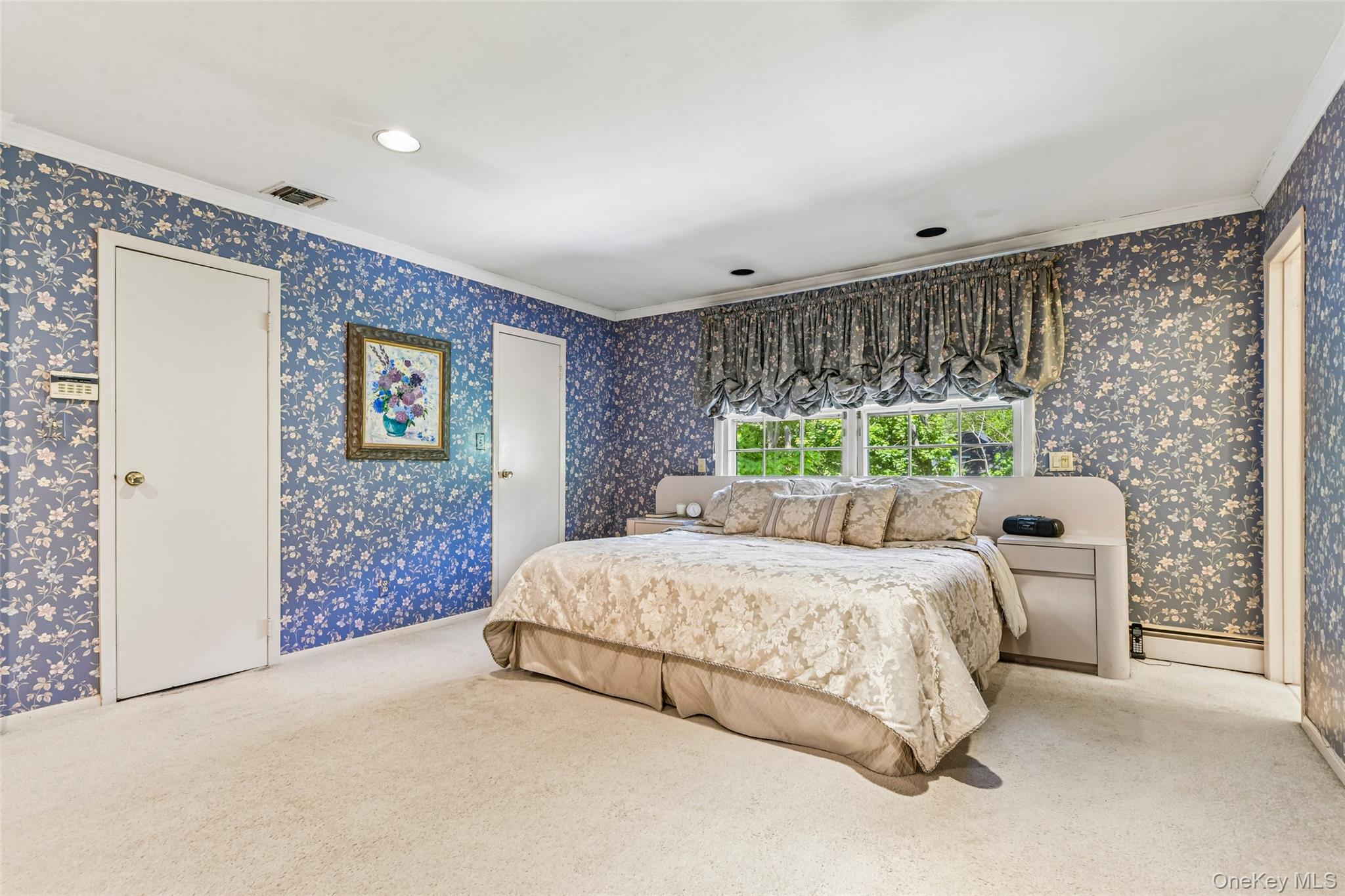 100 Hewlett Neck Road Woodmere, NY 11598 - Photo 23 of 45 a bedroom with a bed lamp and window