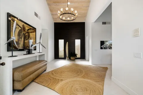 a living room with furniture large window and a fireplace