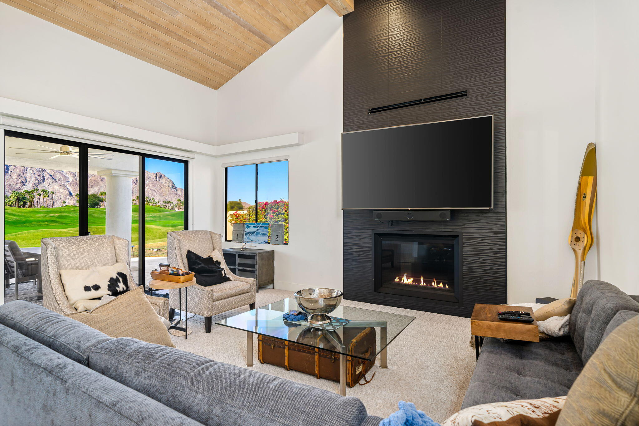54885 Inverness Way La Quinta, CA 92253 - Photo 24 of 53 a living room with furniture fireplace and a large window