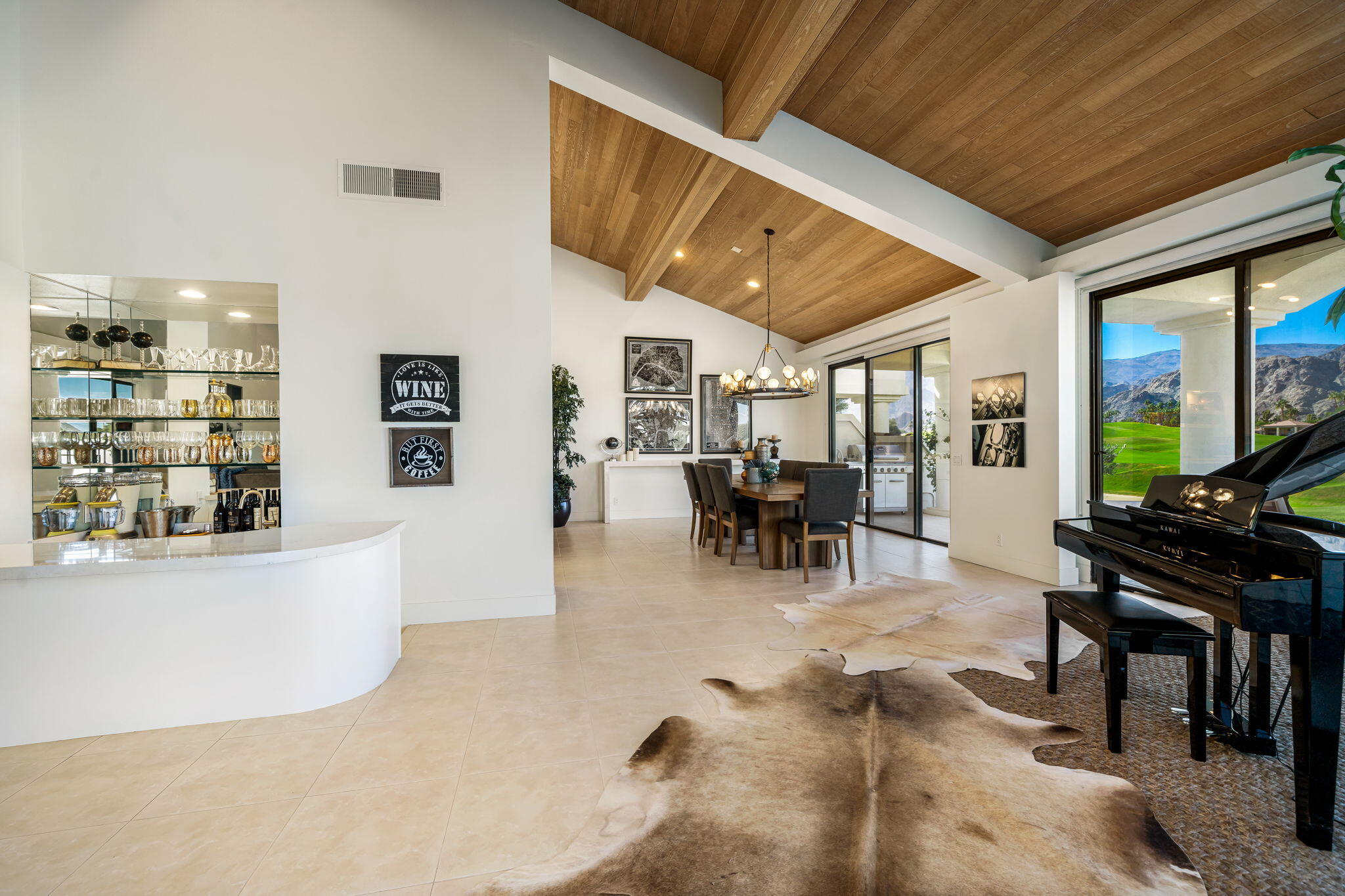 54885 Inverness Way La Quinta, CA 92253 - Photo 27 of 53 a view of a dining room with furniture one side kitchen view and wooden floor