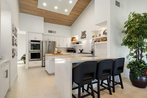 a kitchen with stainless steel appliances a stove a refrigerator and cabinets
