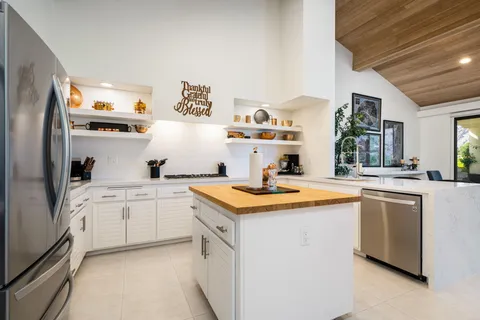 a kitchen with sink and cabinets