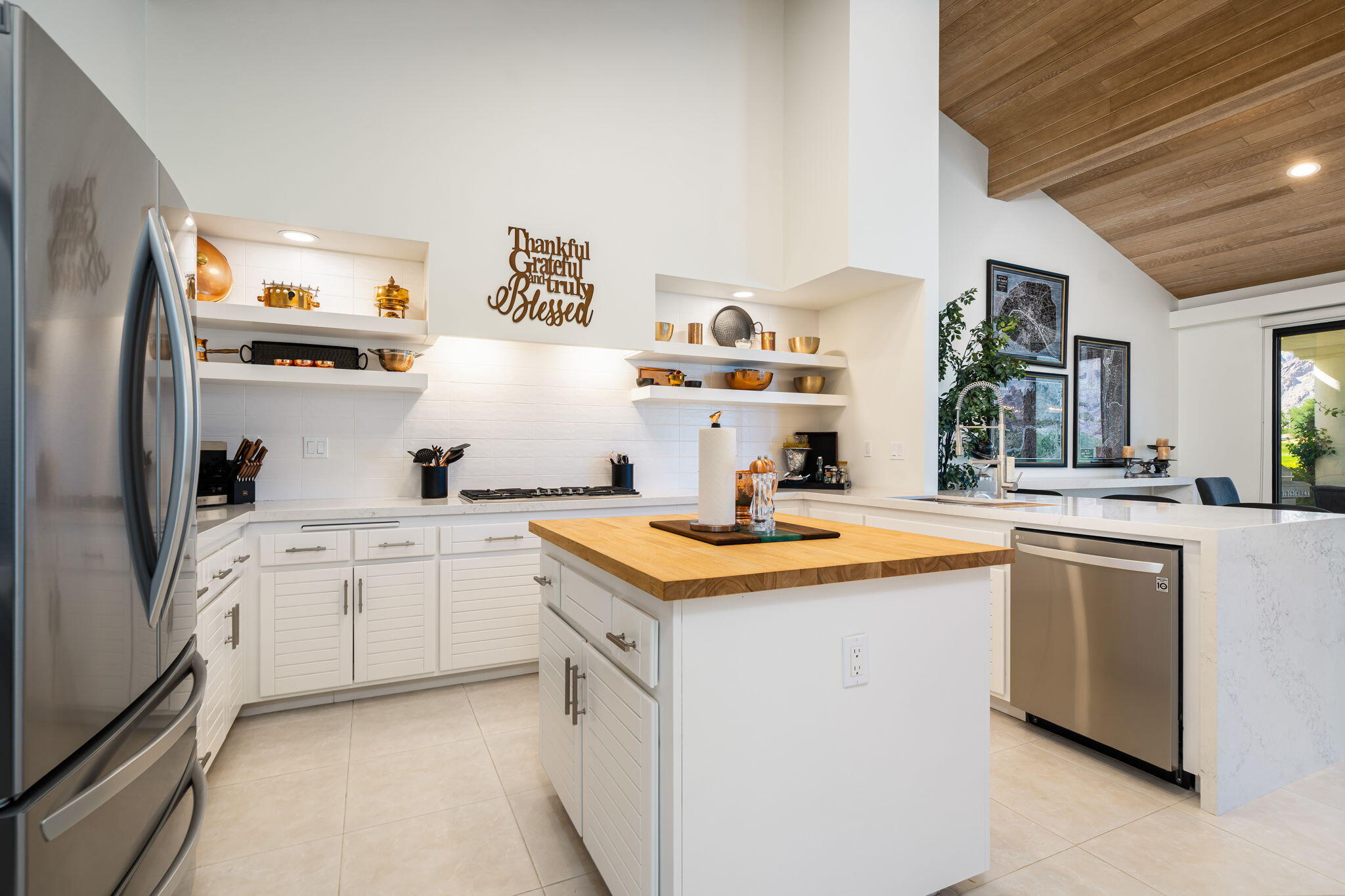 54885 Inverness Way La Quinta, CA 92253 - Photo 36 of 53 a kitchen with stainless steel appliances granite countertop a sink and cabinets