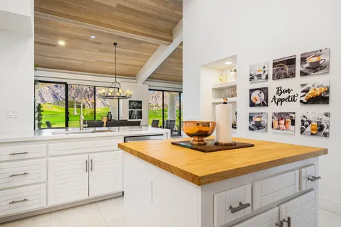 a kitchen with stainless steel appliances granite countertop a sink and a refrigerator