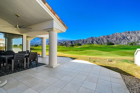 a view of a house with a porch and furniture