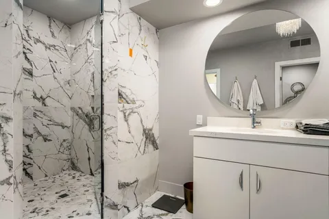 a bathroom with a sink double vanity and a mirror