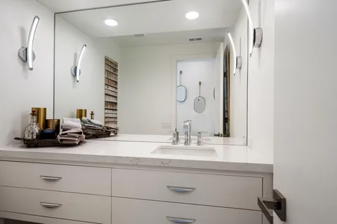 a bedroom with a bed and cabinets