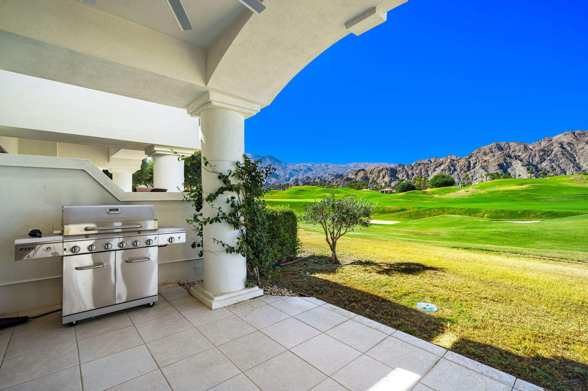 54885 Inverness Way La Quinta, CA 92253 - Photo 5 of 53 a kitchen with a stove and a white cabinets