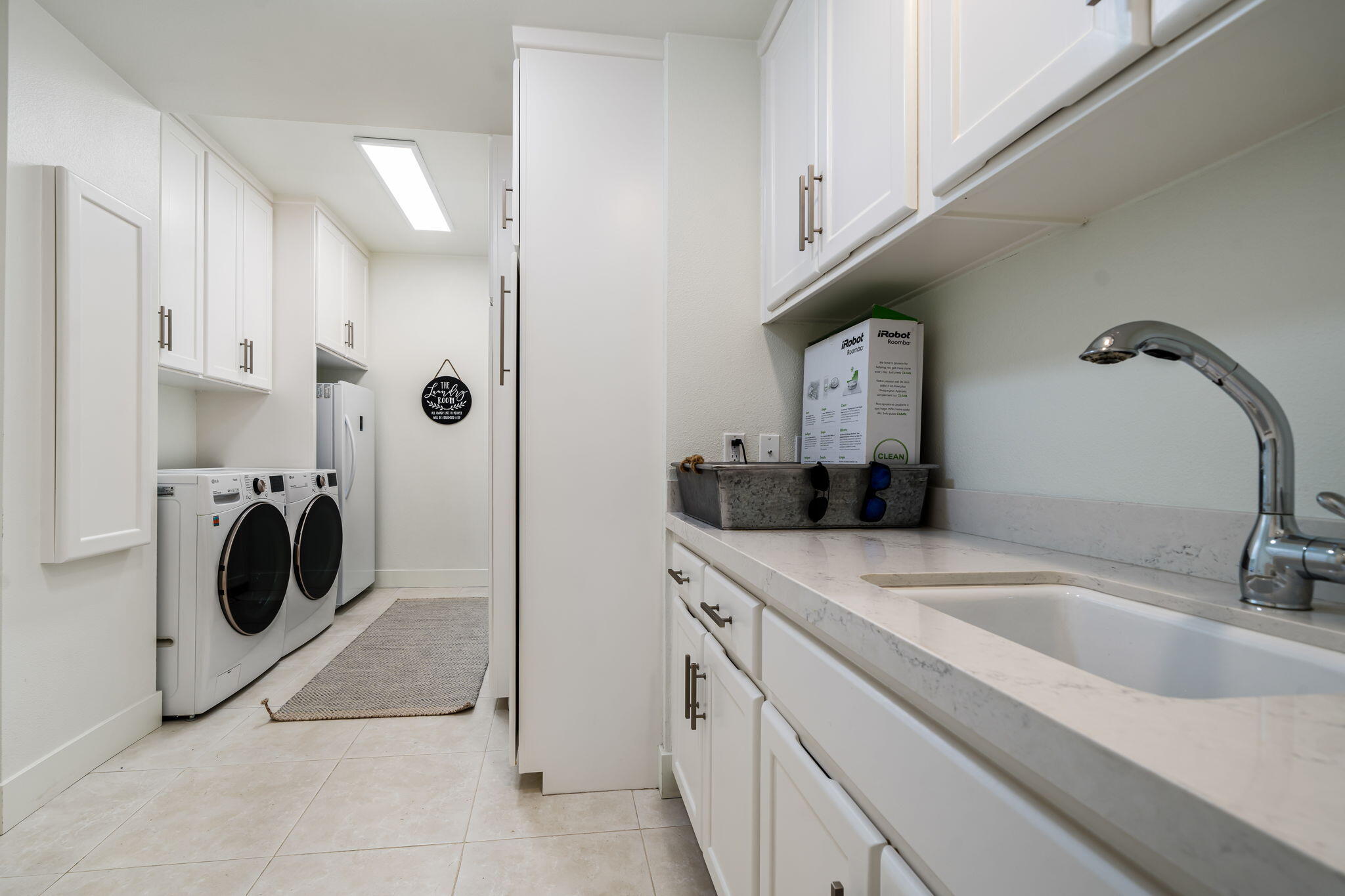 54885 Inverness Way La Quinta, CA 92253 - Photo 53 of 53 a kitchen with a sink a washer and dryer