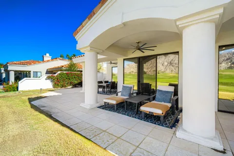 a living room with fireplace furniture and a large window