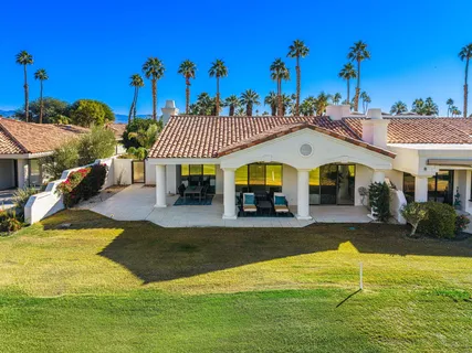 a view of a house with swimming pool and a yard