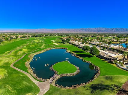 an aerial view of a residential houses with outdoor space and street view