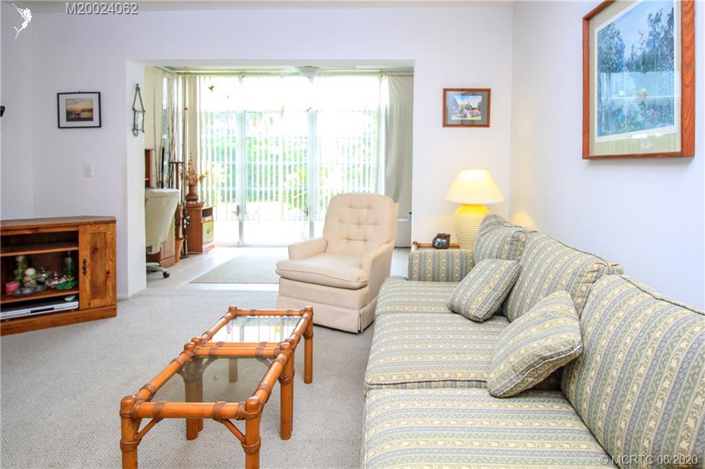 2950 Southeast Ocean Boulevard, Unit 101 Stuart, FL 34996 - Photo 11 of 29 a bedroom with furniture and a fireplace