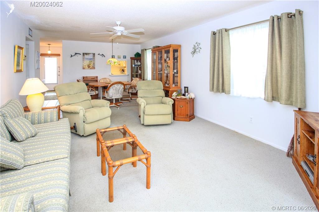 2950 Southeast Ocean Boulevard, Unit 101 Stuart, FL 34996 - Photo 12 of 29 a living room with furniture and a large window
