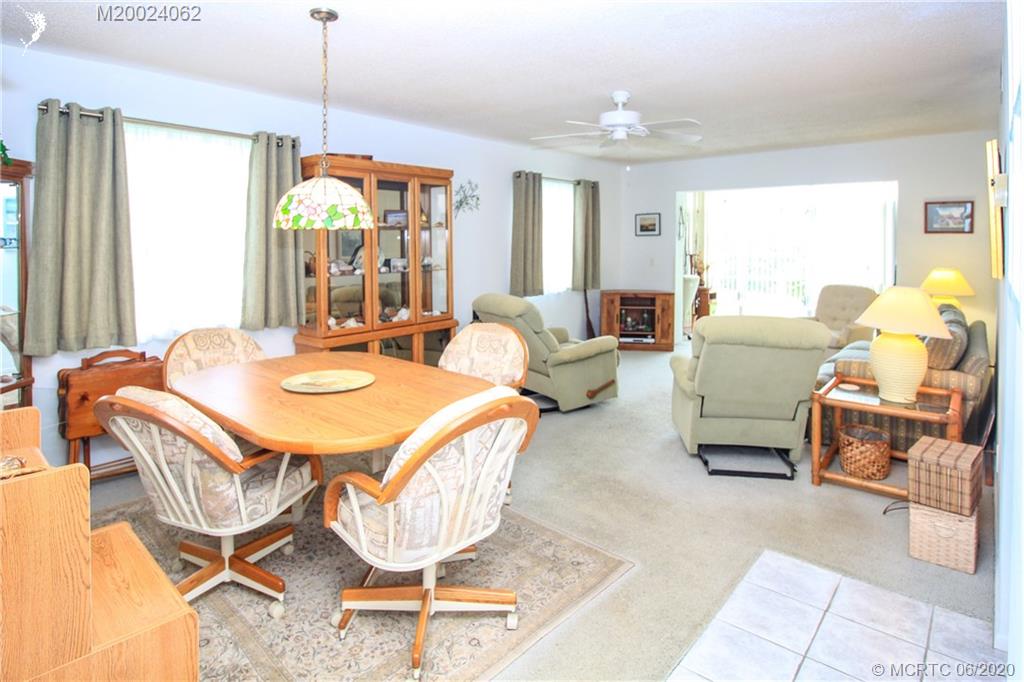 2950 Southeast Ocean Boulevard, Unit 101 Stuart, FL 34996 - Photo 13 of 29 a dining room with furniture a chandelier and window