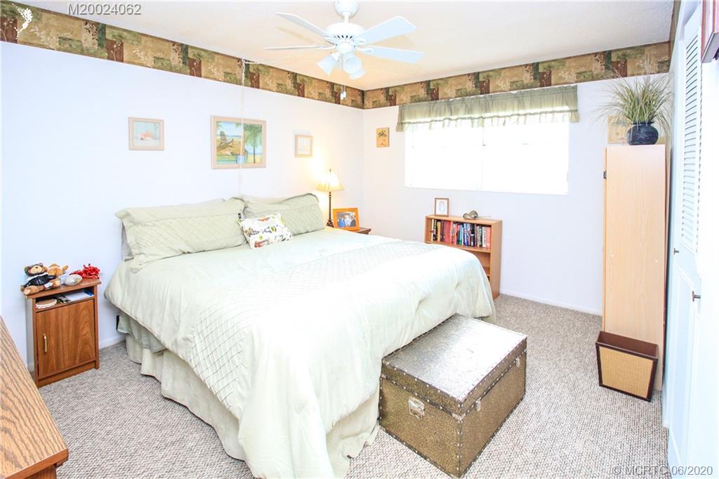 2950 Southeast Ocean Boulevard, Unit 101 Stuart, FL 34996 - Photo 14 of 29 a bedroom with a bed and a window