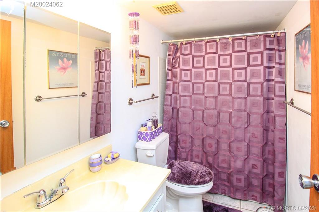 2950 Southeast Ocean Boulevard, Unit 101 Stuart, FL 34996 - Photo 16 of 29 a bathroom with a sink toilet and shower