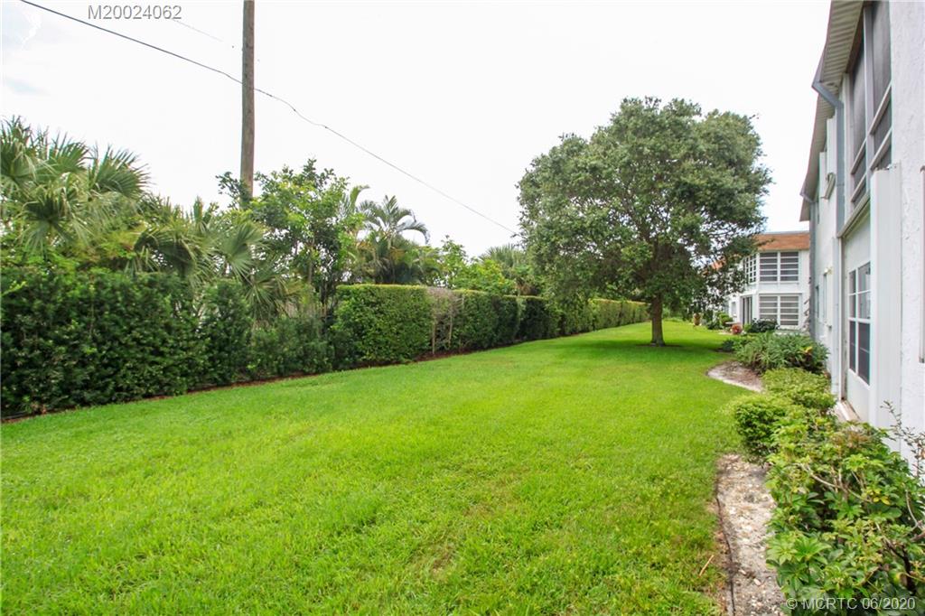 2950 Southeast Ocean Boulevard, Unit 101 Stuart, FL 34996 - Photo 24 of 29 a view of a field of grass and trees