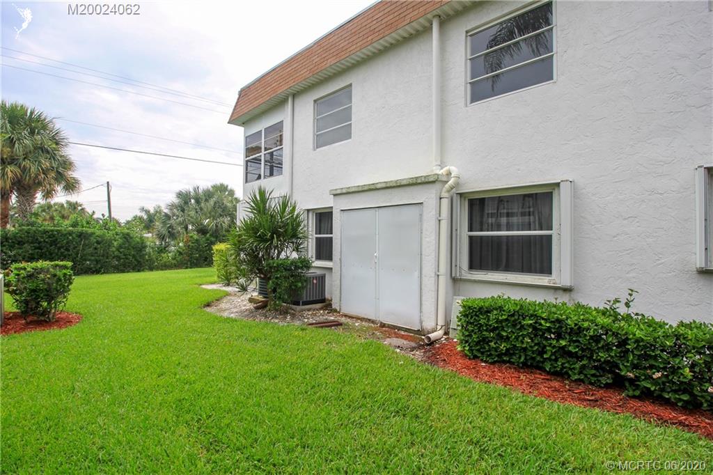 2950 Southeast Ocean Boulevard, Unit 101 Stuart, FL 34996 - Photo 25 of 29 a view of a house with backyard and garden