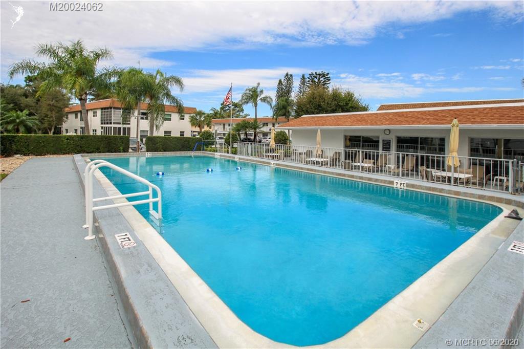 2950 Southeast Ocean Boulevard, Unit 101 Stuart, FL 34996 - Photo 27 of 29 a view of a swimming pool with a patio